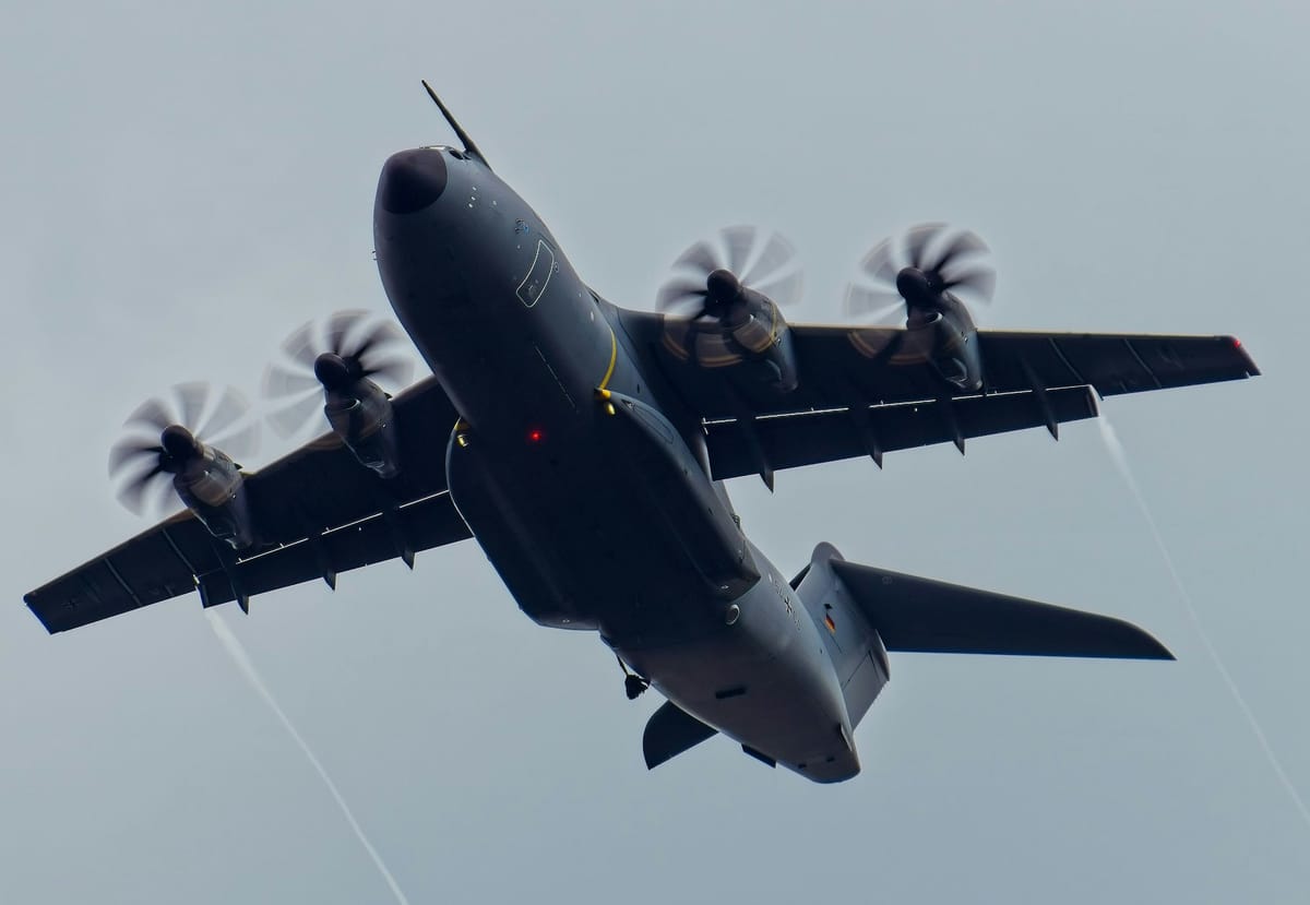 large air plane flying through a cloudy sky -- Photo by Julian Zwengel / Unsplash
