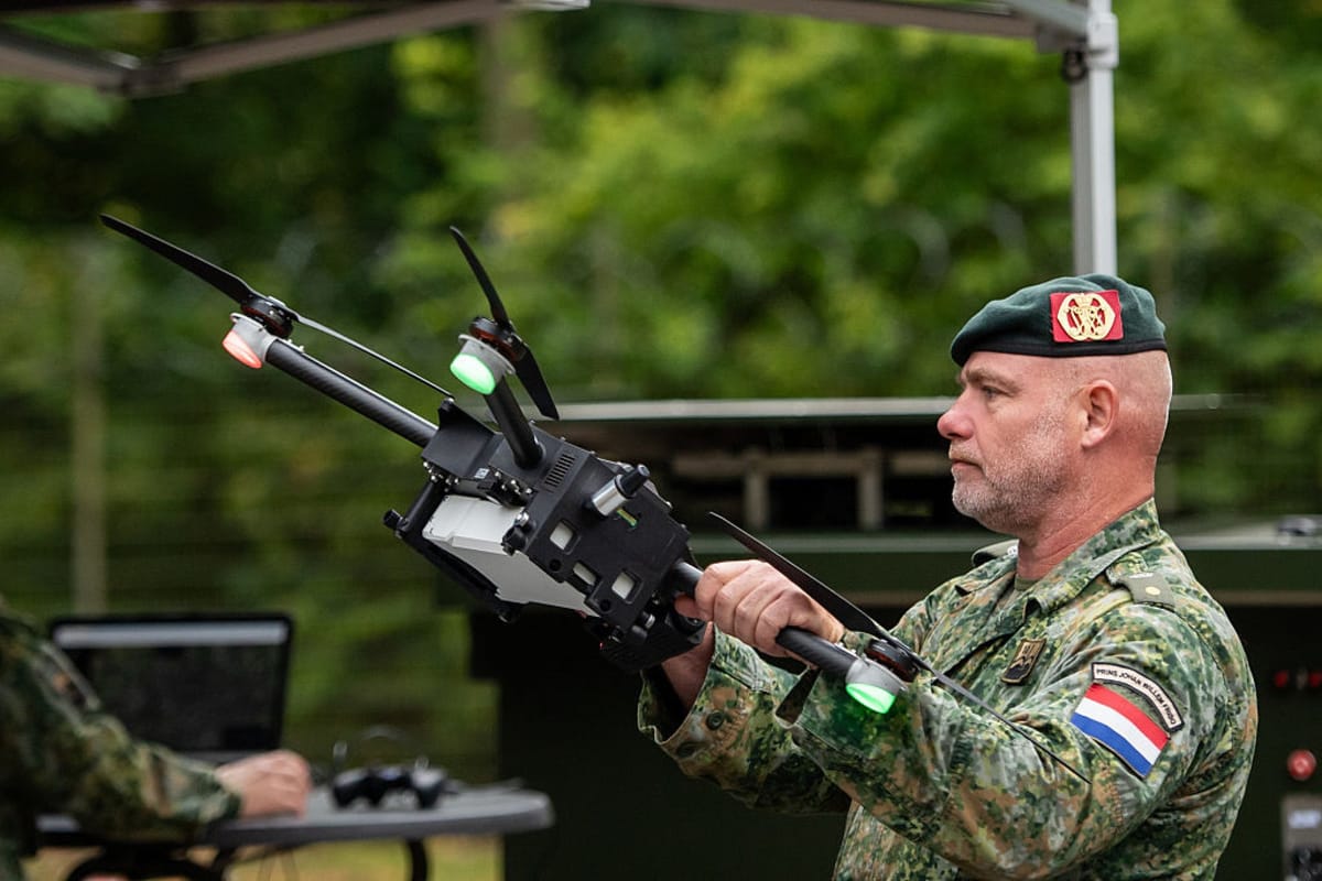 A member of the Netherlands Corps holds a drone 
