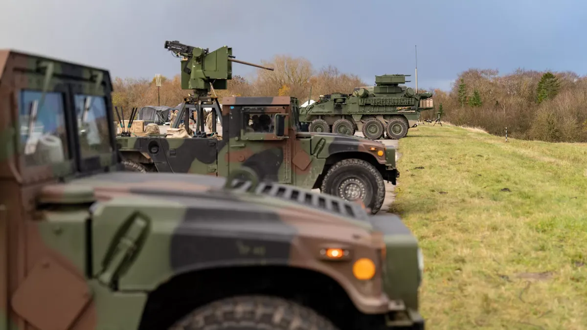 Military personnel operating counter-drone equipment at a training range in Germany.